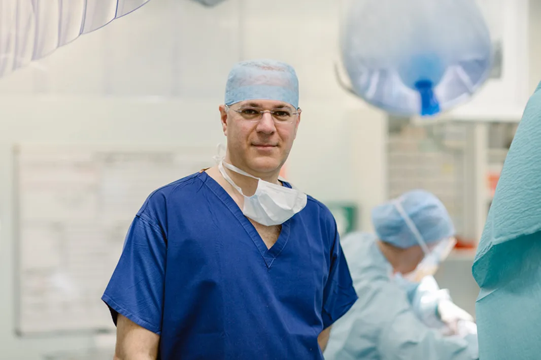 An orthopaedic surgeon in an operating theatre, SOS partners with surgeons on post-operative rehabilitation.
